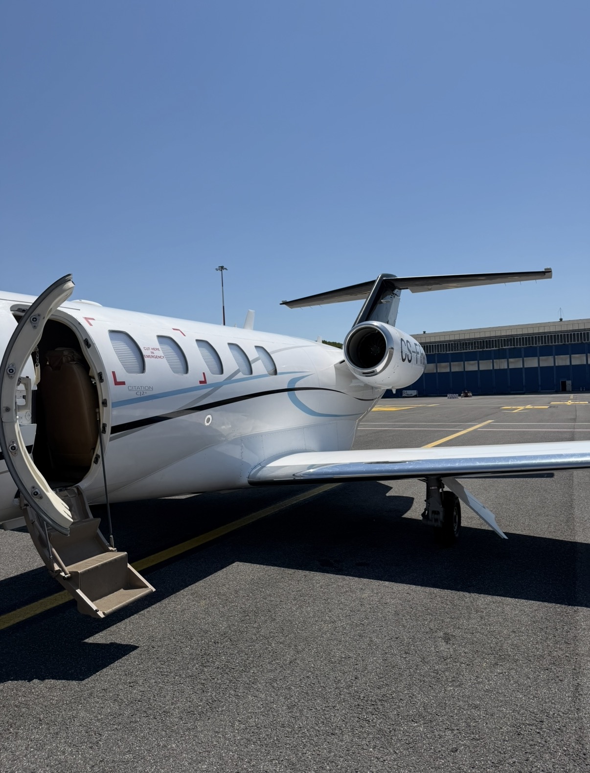 A Citation CJ2 waiting on the apron with its cabin door open