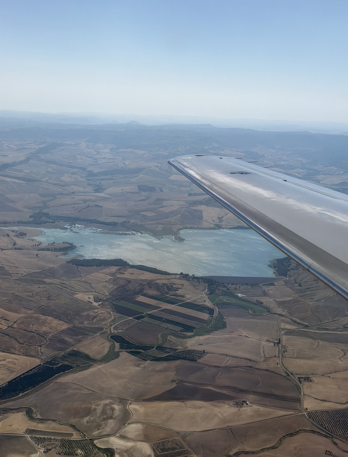 The Mediterranean coastline seen from the wing of a private jet